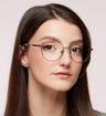Shiny Rose Gold Aspire Jane Oval Glasses - Modelled by a female
