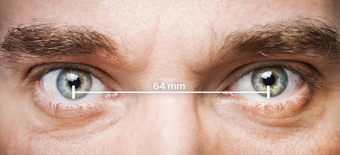 A man's eyes with a line denoting a PD of 64mm