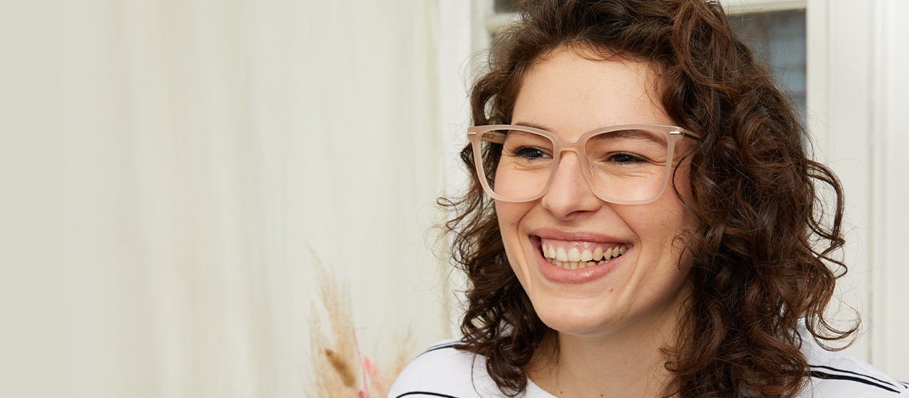 Woman wearing beige square frames laughing
