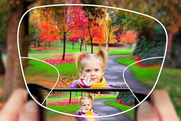 View of a child having their picture taken in the park through a varifocal lens