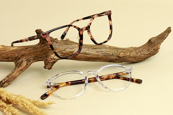 Arden glasses frames next to a piece of wood