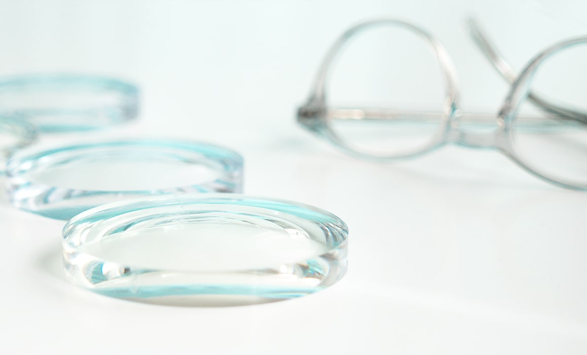 Glasses lenses lying next to a frame