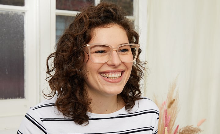 Woman wearing beige square frames laughing