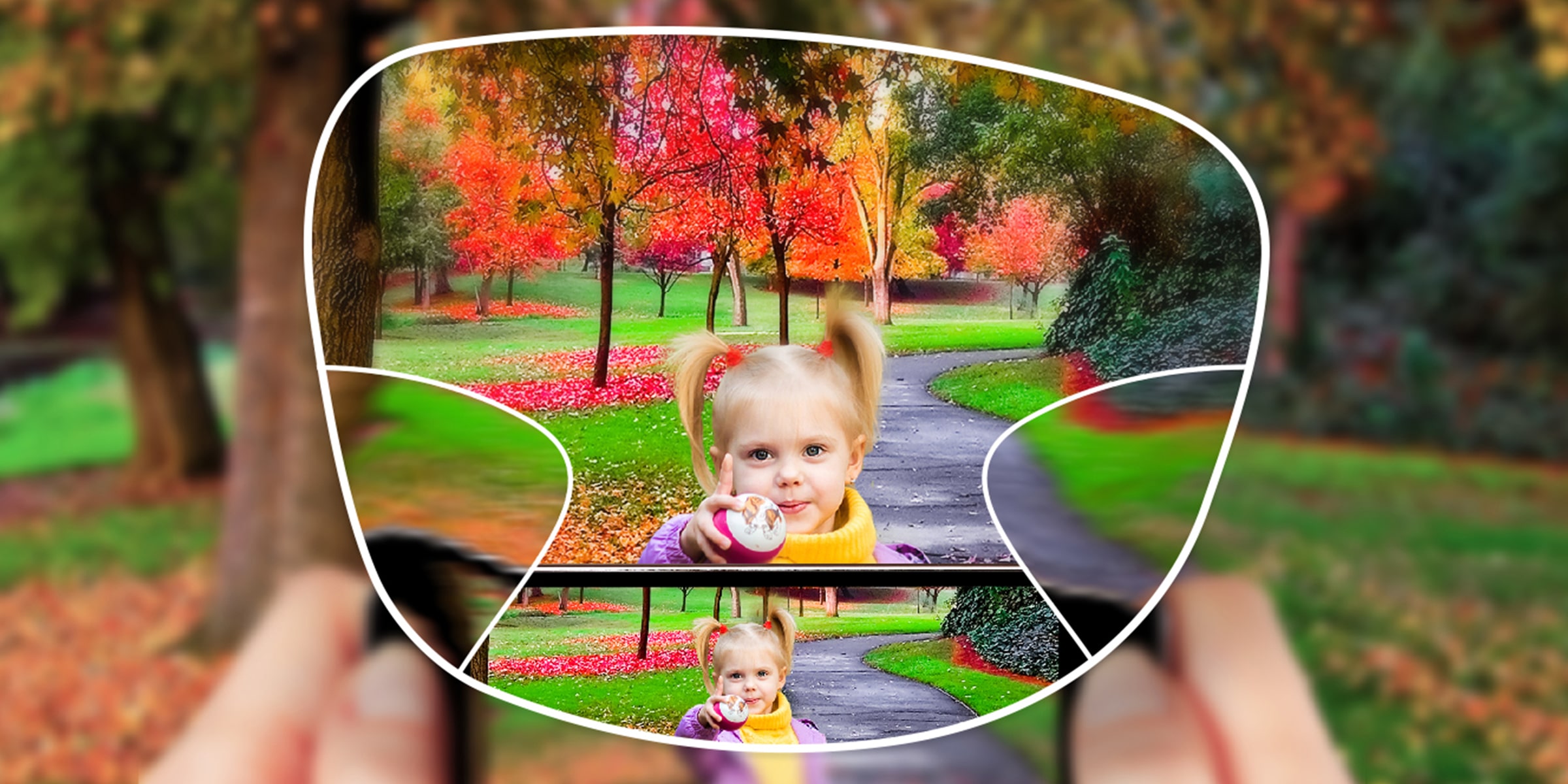 View of a small child in a park with autumnal trees, also visible through the lens of a phone camera. The whole scene is seen through a KODAK Easy2 Max Lens. Everything is in clear focus except for two small triangular patches to the left and right.