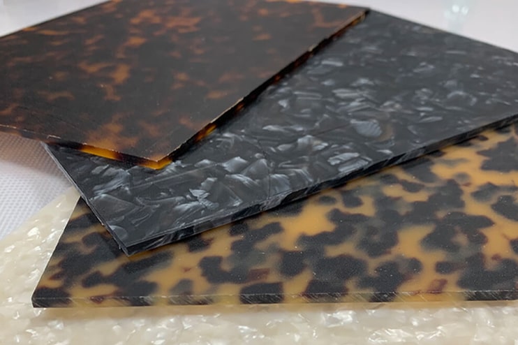 Flat sheets of acetate in different colours with different patterns lying on a table