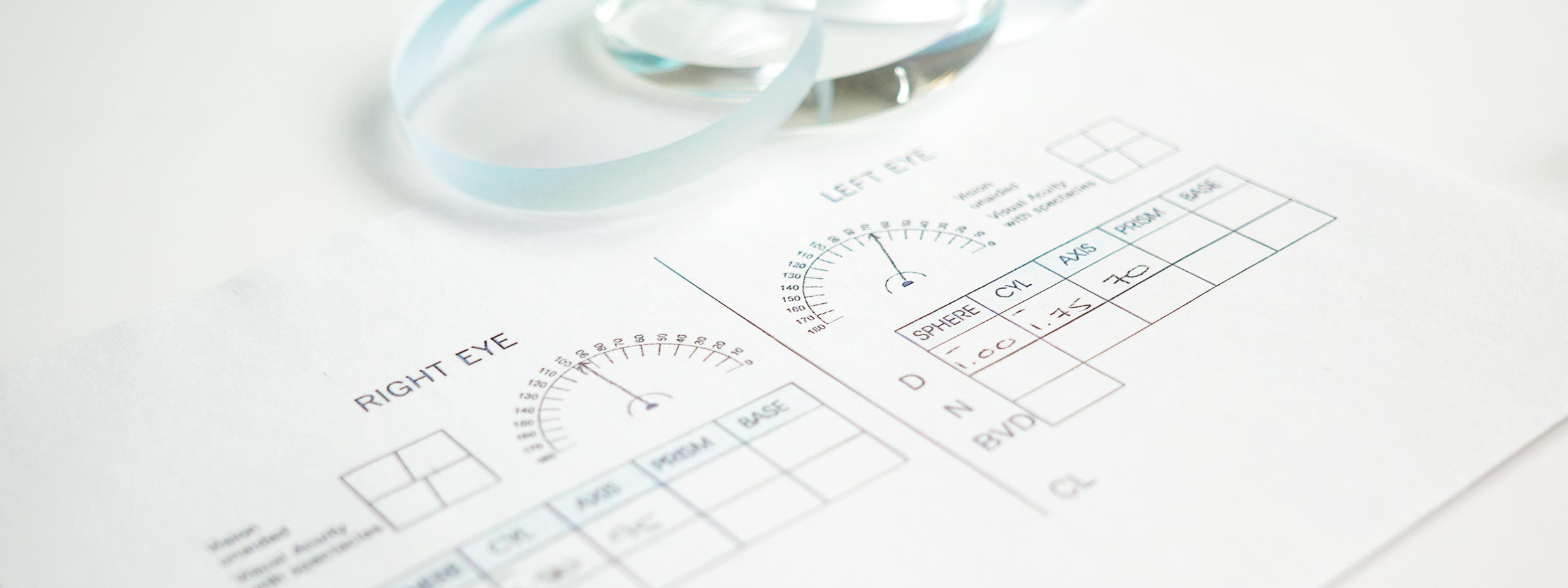 Lenses lying next to a prescription form