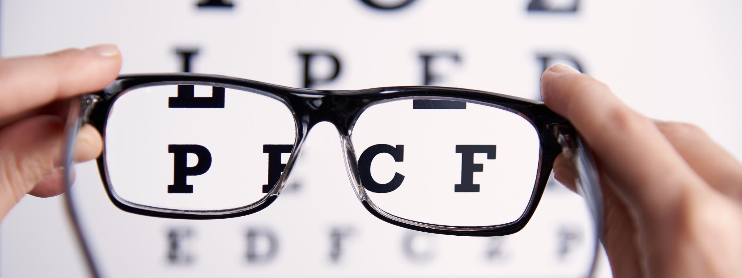 An eye chart appearing more focused through a pair of glasses