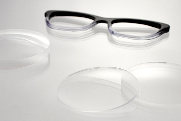 Glasses parts, including frames and lenses, lying next to each other on a table