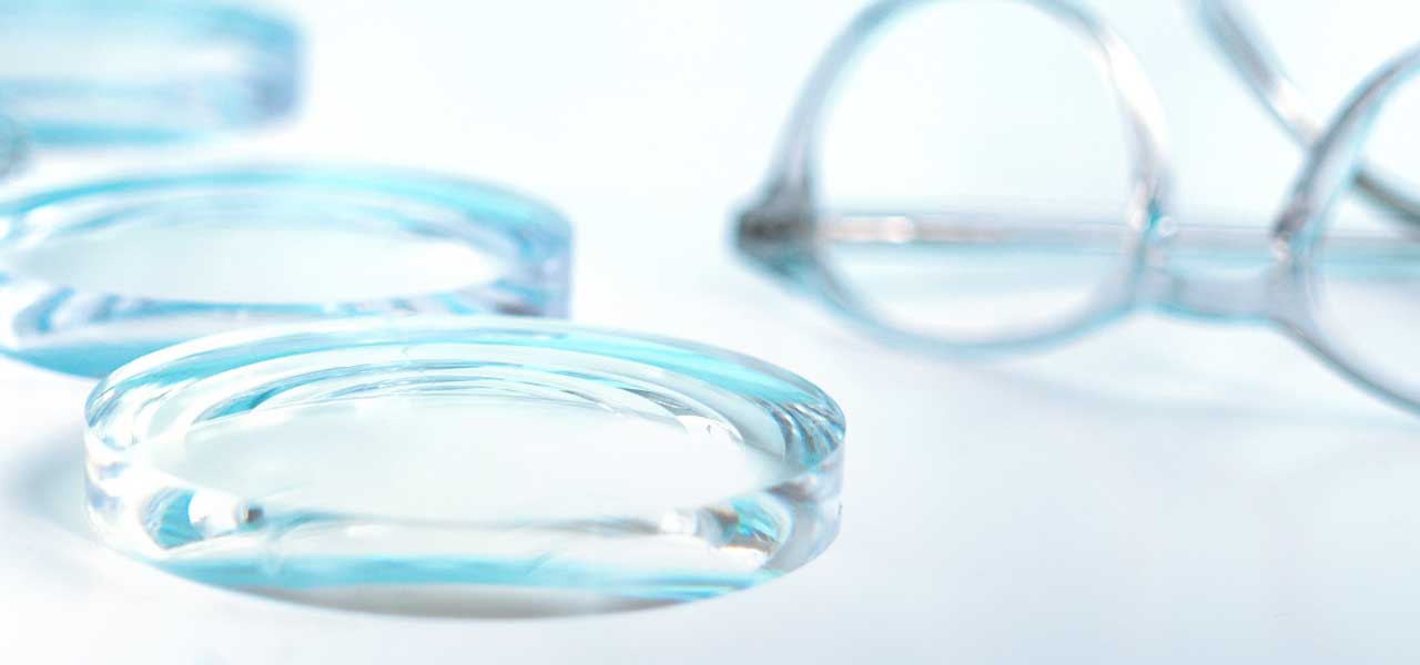 Glasses lenses lying next to a frame