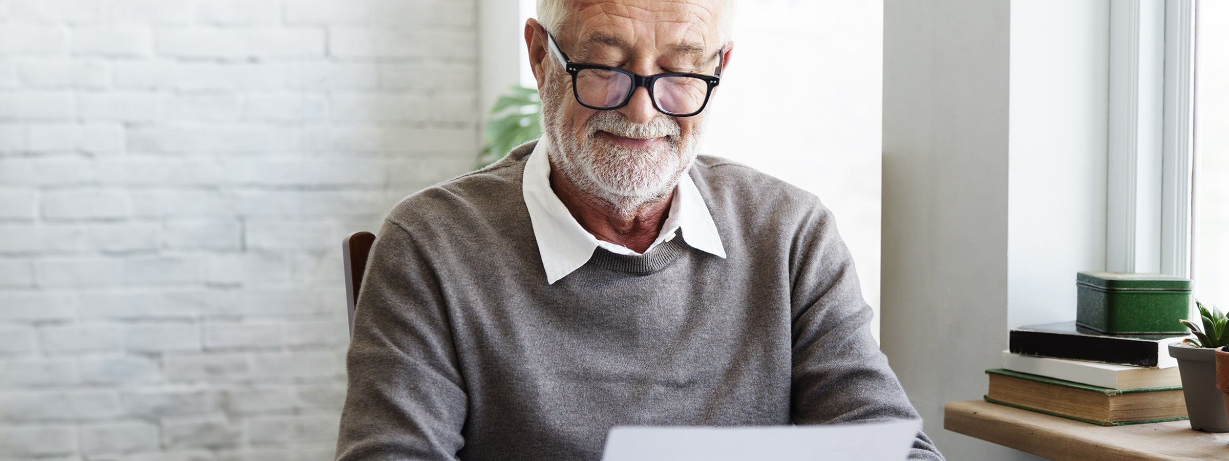 An older man reading through glasses