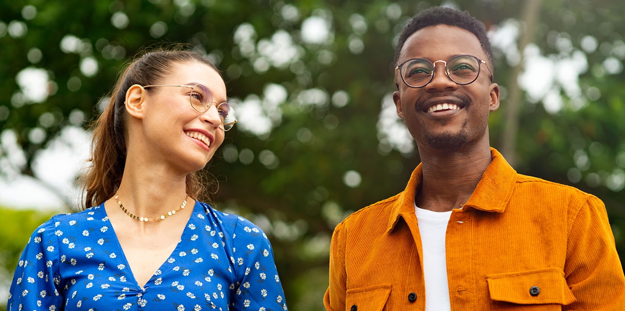 Happy man and woman wearing glasses outdoors