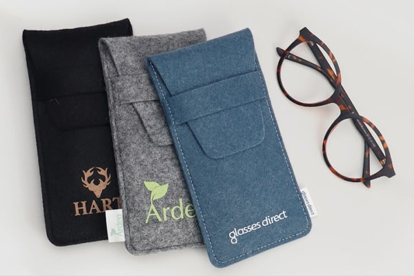 Glasses frame next to Glasses Direct branded soft pouches