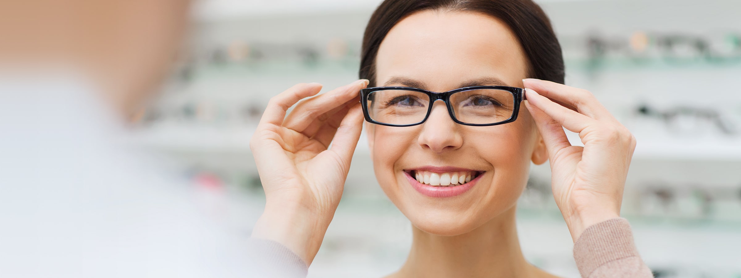Woman putting on a pair of glasses